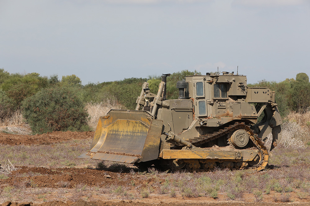 Armored bulldozer working on open terrain
