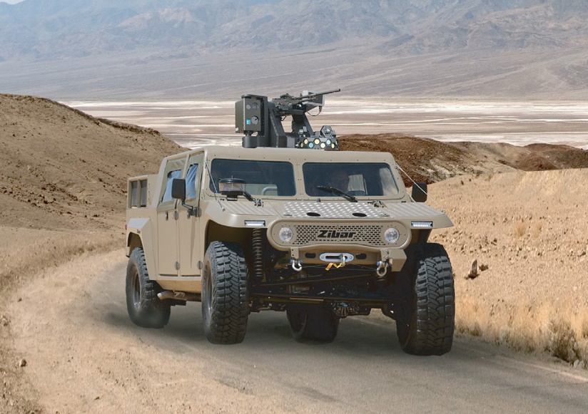 Armored off-road vehicle with roof-mounted weapon station on a road