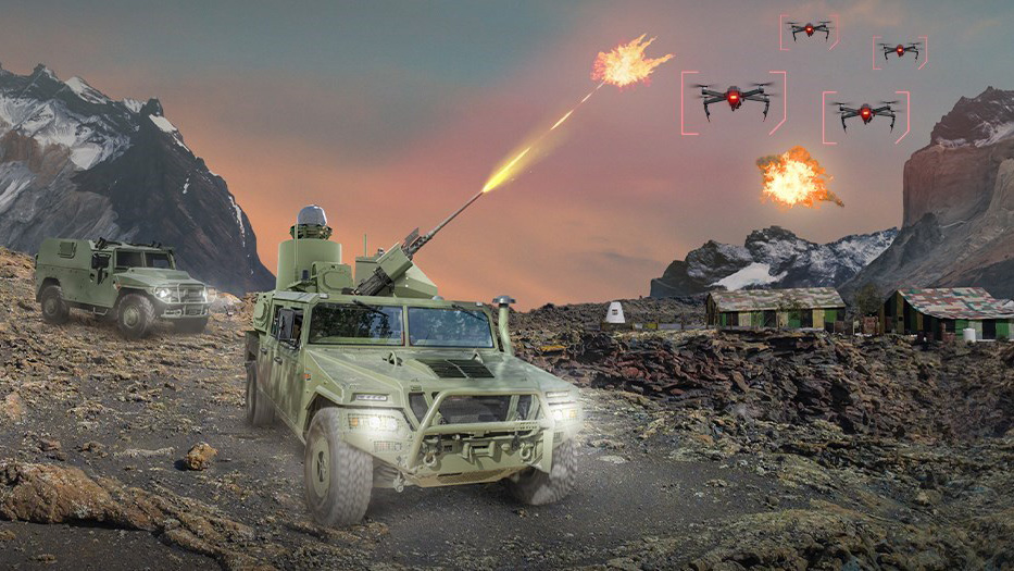 Military vehicle engaging drones in mountainous terrain at dusk
