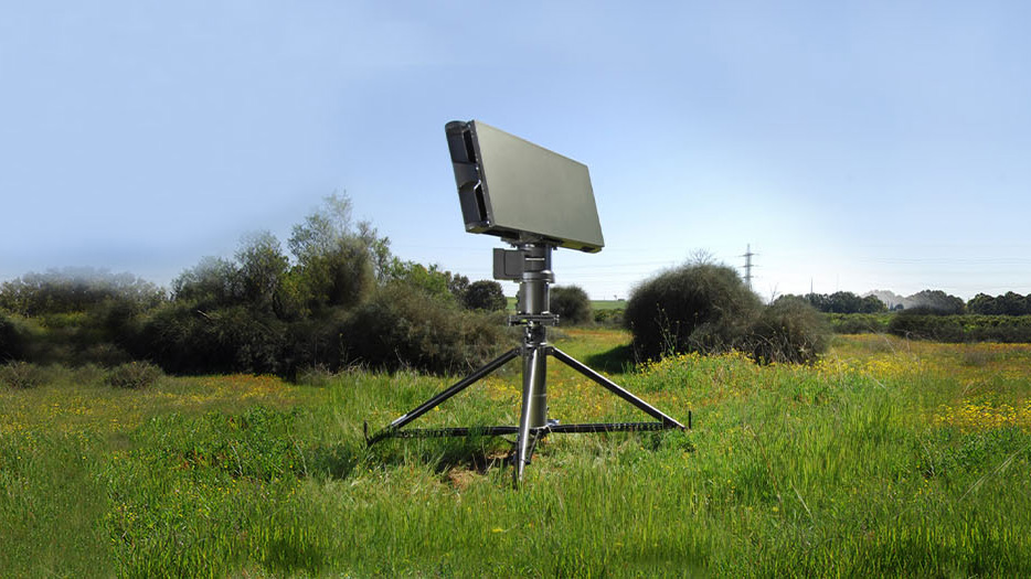 Radar panel on a tripod in a green meadow