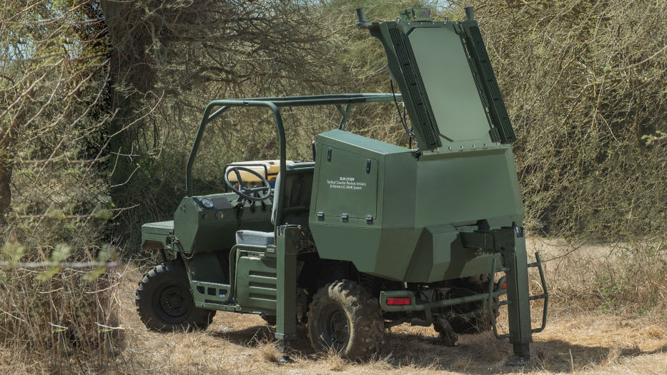 Utility vehicle with a folding radar panel among trees