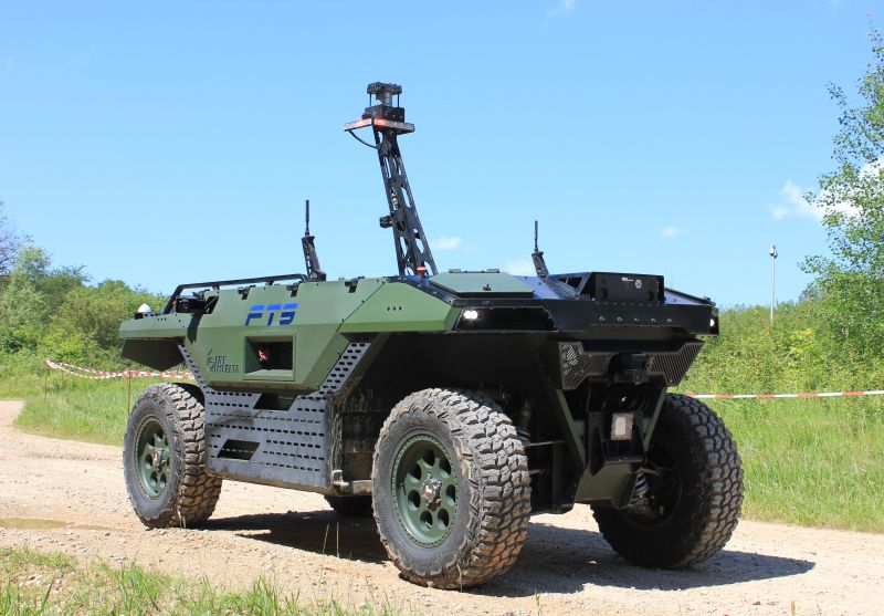 Unmanned ground vehicle with sensor mast on a gravel track
