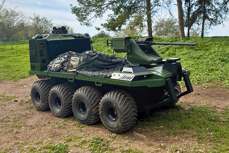 Eight-wheeled unmanned ground vehicle with weapon station on grass
