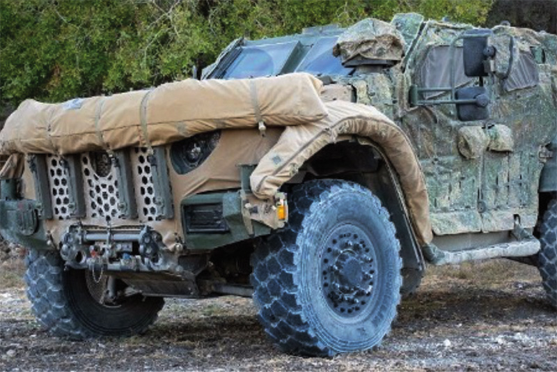 Military vehicle covered with a camouflage system