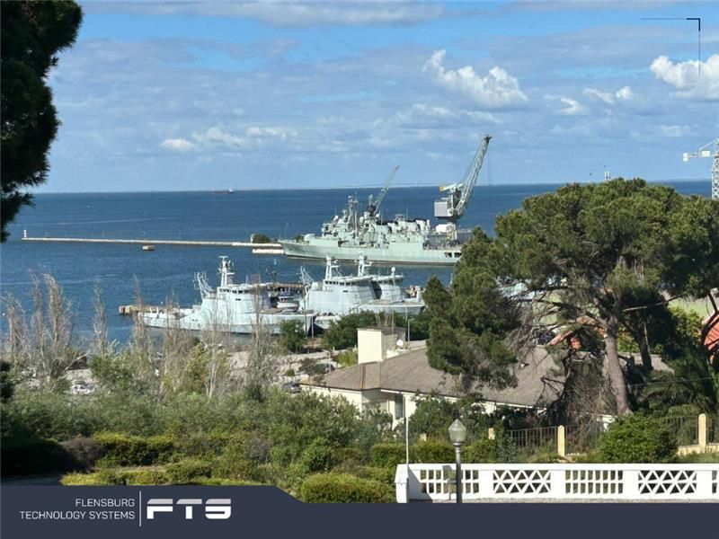 Harbor with naval ships seen from a hillside