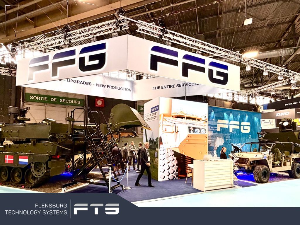 Large exhibition booth with military vehicles on display