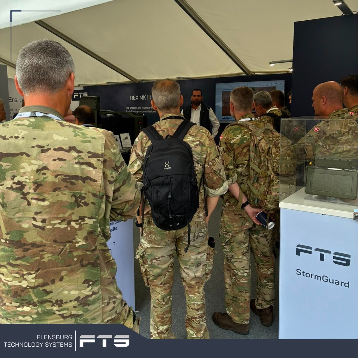 Visitors in uniform at an exhibition stand
